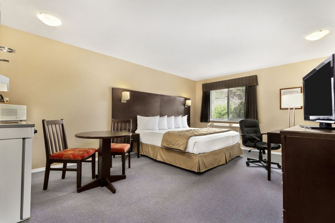 Guest room with two queen beds and a dining table