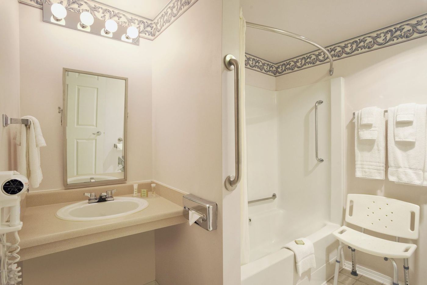 Accessible bathroom with grab bars and roll-in shower